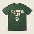 Forest-green Kindness Club T-shirt concept mockup with ivory lettering and hands holding a daisy