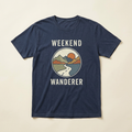 Navy T-shirt concept mockup with Weekend Wanderer lettering and a vintage mountain road, pine forest and sunset graphic