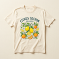 Cream T-shirt concept mockup with Citrus Season lettering, yellow lemons, oranges and green leaves